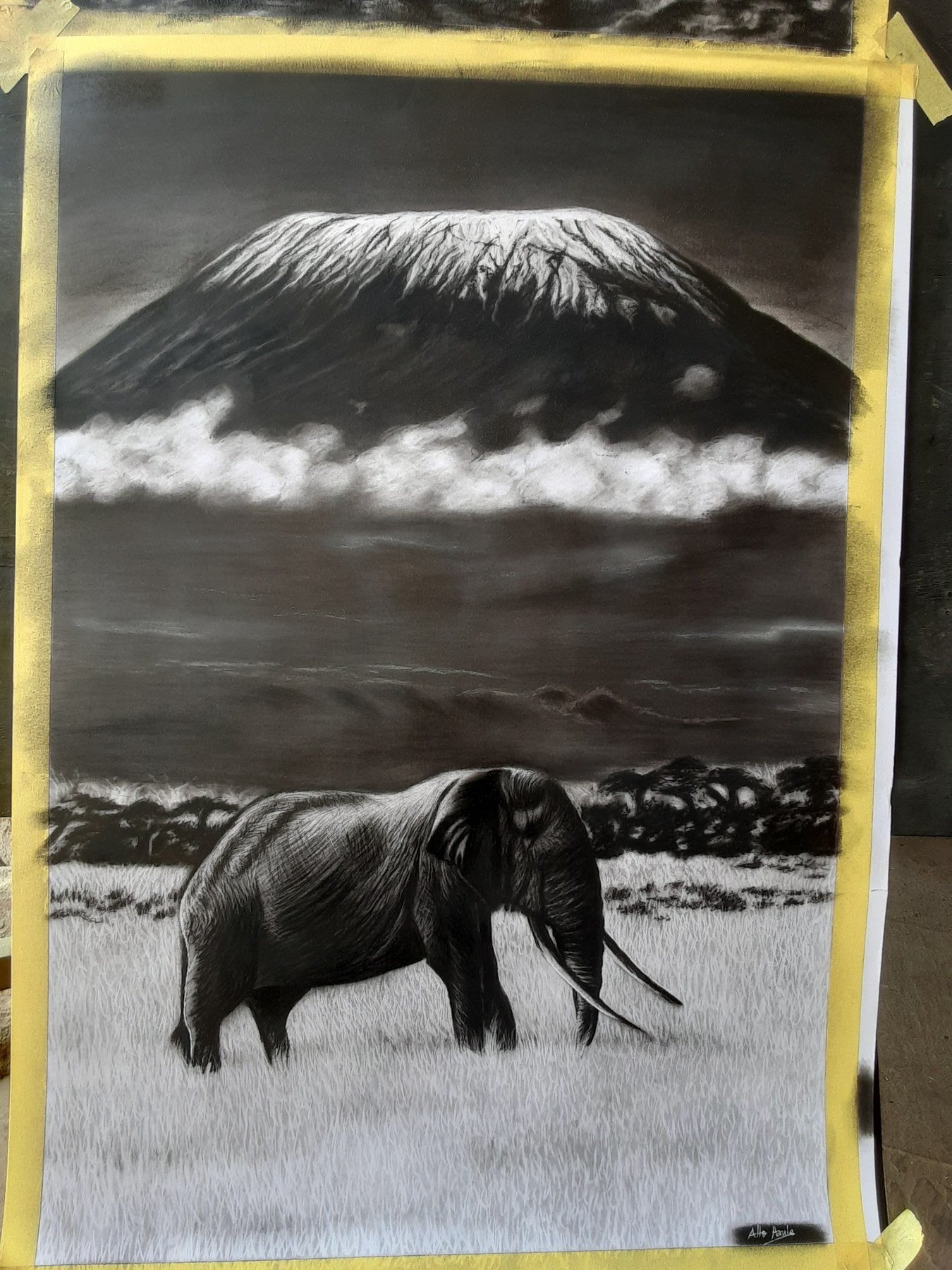 Black and white artwork of an elephant with Mount Kilimanjaro